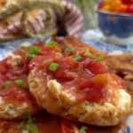 Southern Tomato Gravy Recipe (Old-Fashioned Country Tomato Gravy) served on a blue and white plate with biscuits and garnished with scallions