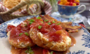 Southern Tomato Gravy Recipe (Old-Fashioned Country Tomato Gravy) served on a blue and white plate with biscuits and garnished with scallions