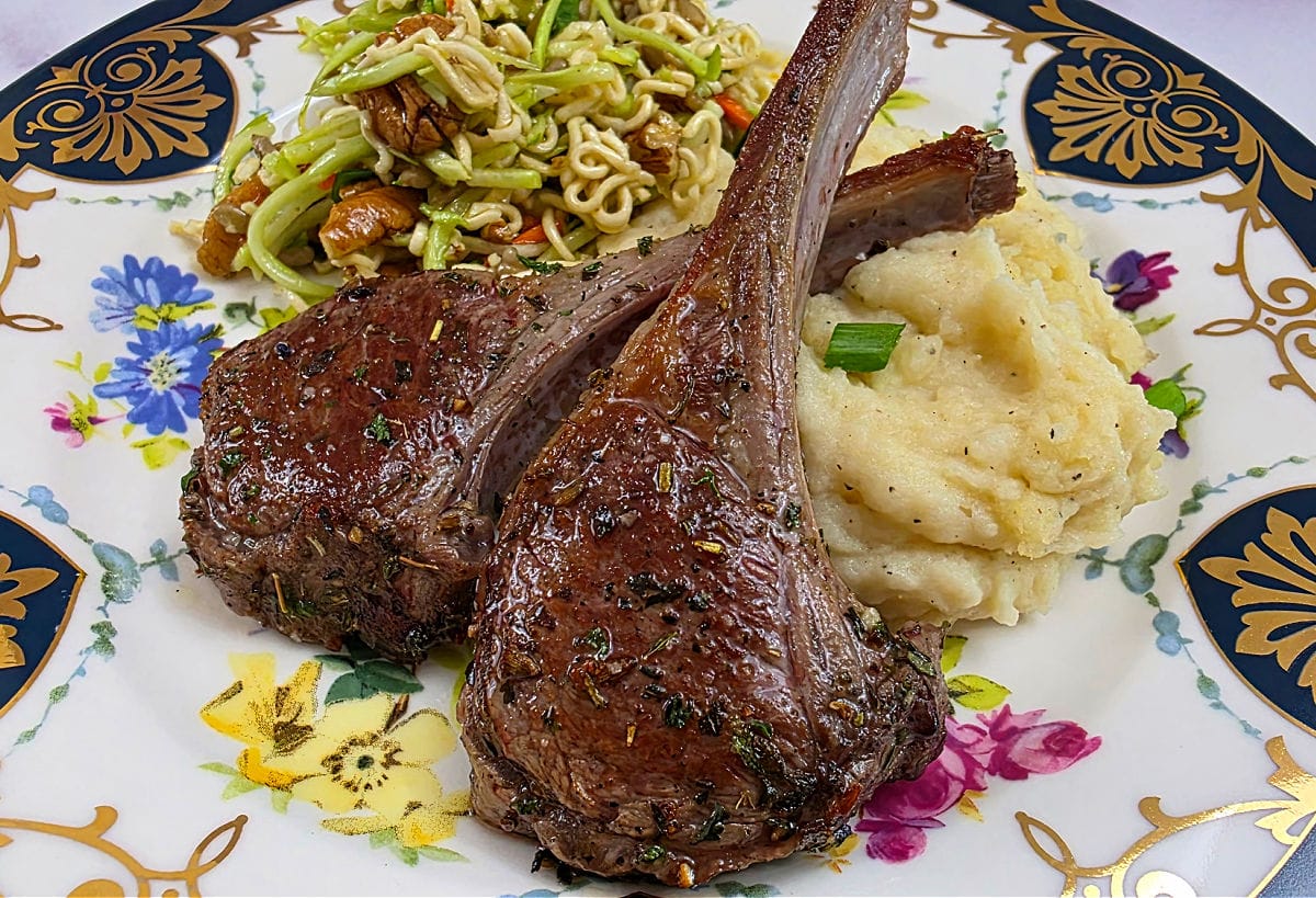 Easy lamb chops recipe with flavorful marinade. Baby lamb chops on a bed of mashed potatoes.