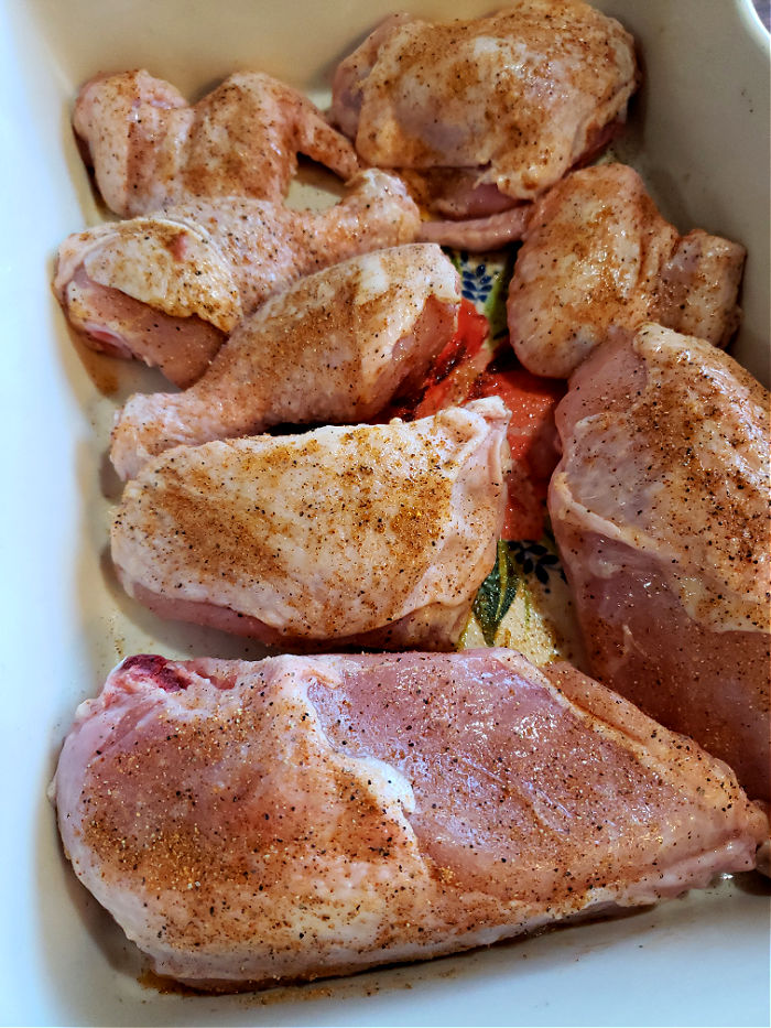 seasoned chicken ready for roasting in the oven