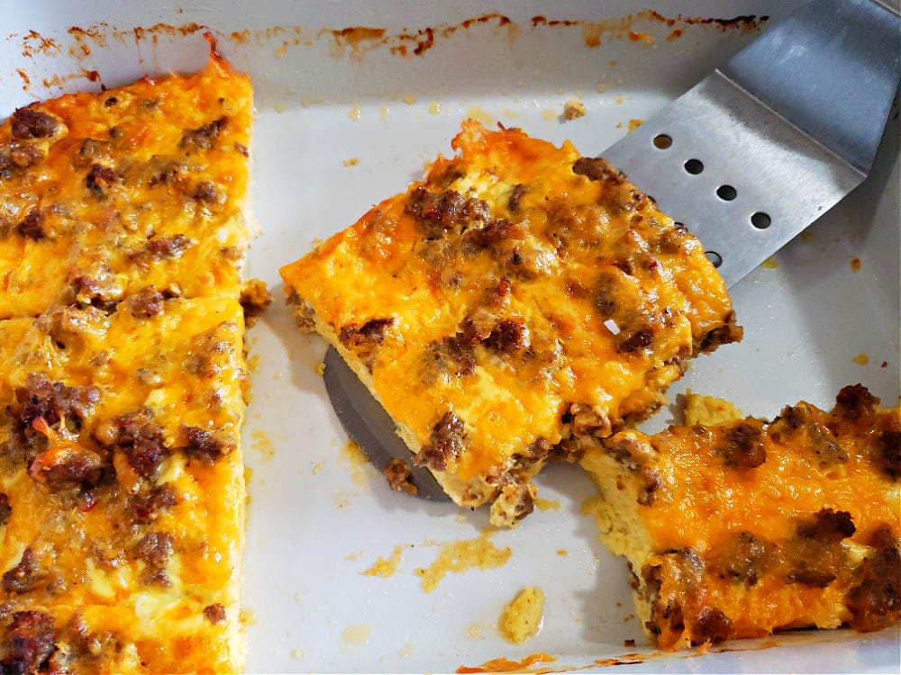 white casserole dish with simple breakfast casserole and a spatula