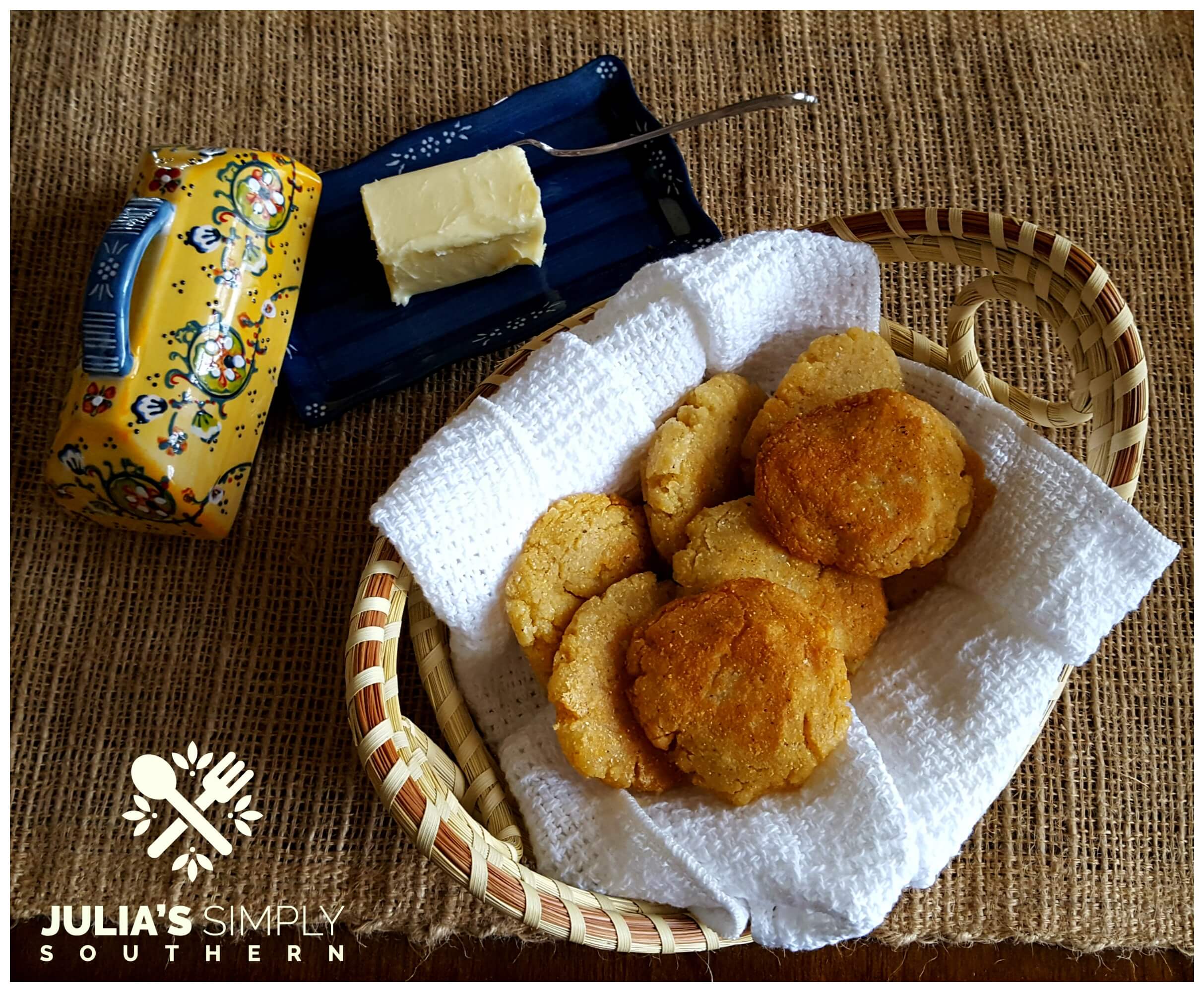 https://juliassimplysouthern.com/wp-content/uploads/Charleston-Sweetgrass-basket-with-hot-water-cornbread-fritters-on-a-while-cotton-towel-next-to-soft-creamy-butter-Julias-Simply-Southern.jpg