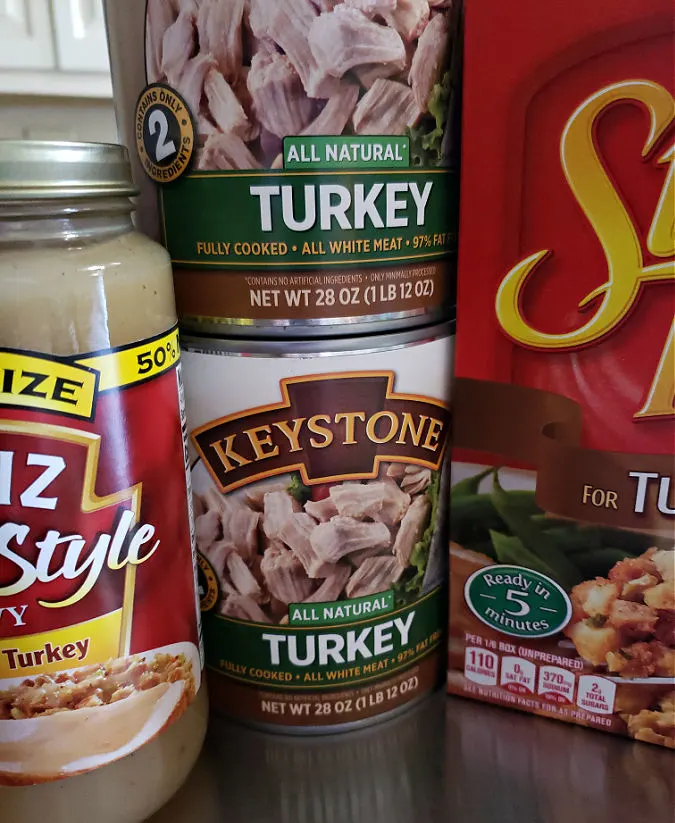 Ingredients for Thanksgiving casserole dinner made with canned turkey meat, jarred gravy, and Stove Top stuffing mix