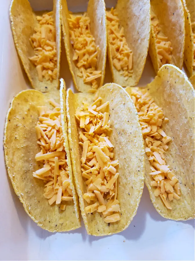 Shredded Cheddar in crunchy taco shells with flat bottoms