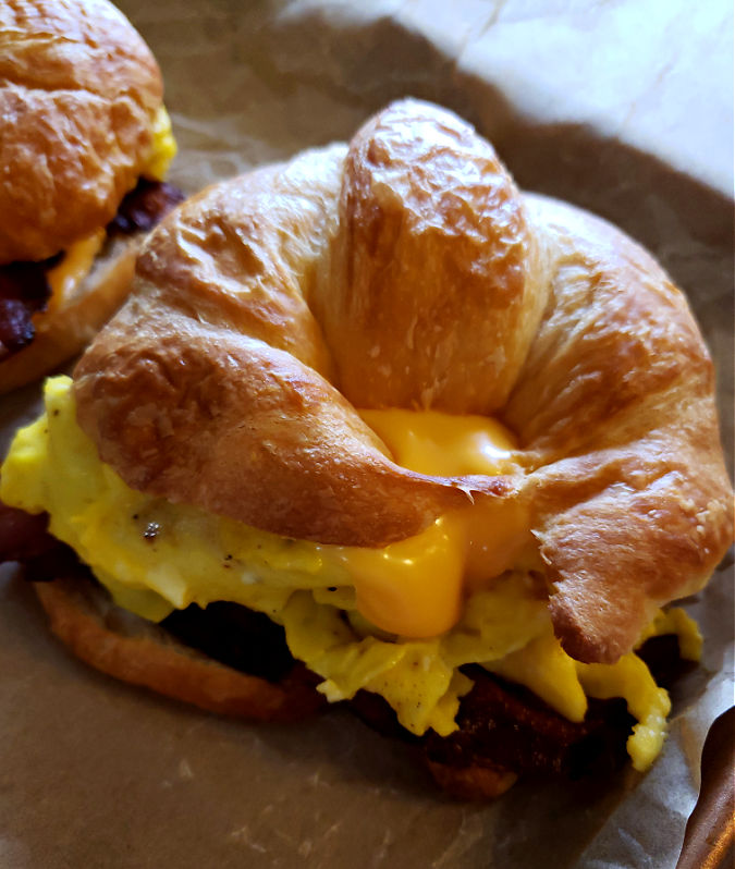 Breakfast Croissant Sandwich with bacon, egg and melted cheese