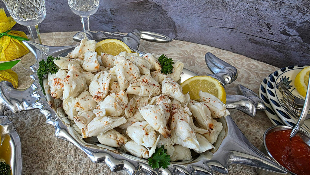 Elegant crab cocktail appetizer with sparkling wine in the background