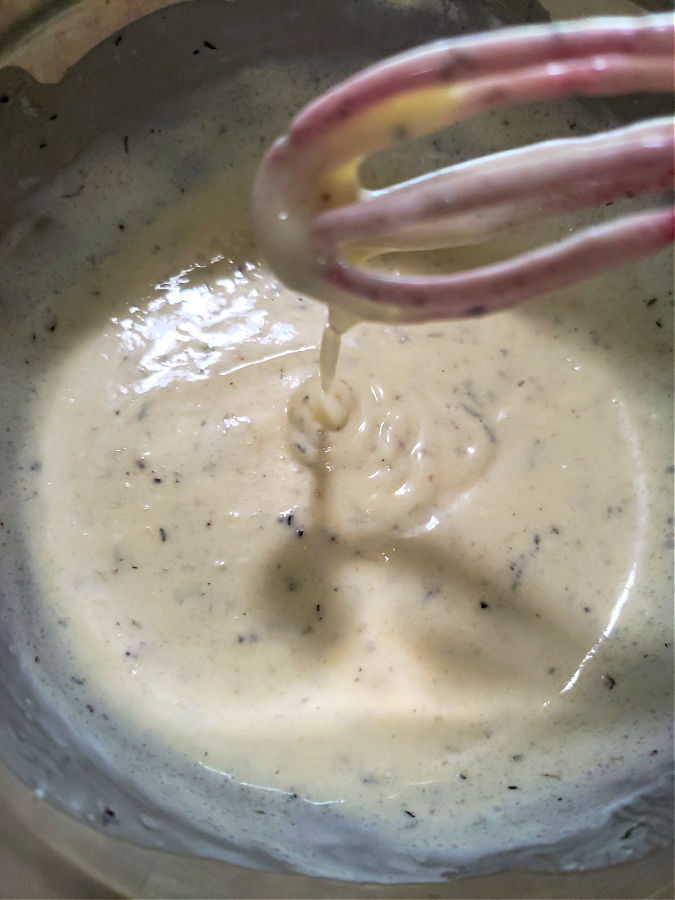 combining the sweet creamy mayonnaise dressing for Southern-style coleslaw
