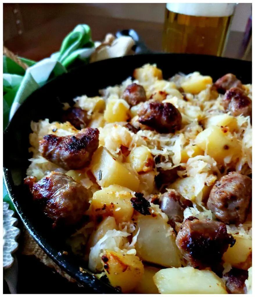 sausage and potato skillet dinner with a mug of beer