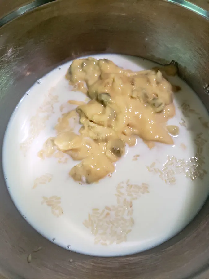 cream of celery condensed soup, milk and rice in a stainless mixing bowl
