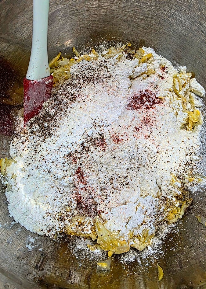 mixing bowl with grated squash, onion, flour, cornmeal, egg and seasonings