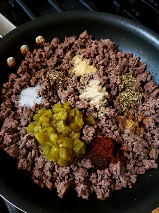 Cooked minced ground beef with Mexican cuisine seasonings and green chili peppers