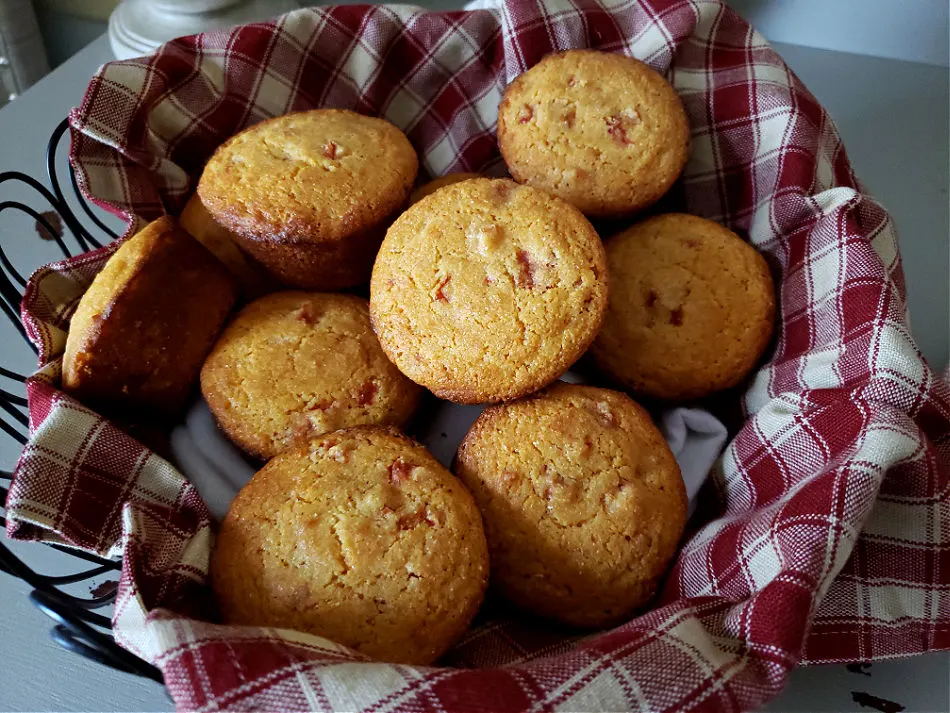 Tomato cornbread muffins in a towel lined bread basket. Appalachian Tomato Corn Muffin Recipe.