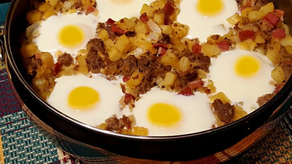 Large skillet with country breakfast hash with eggs