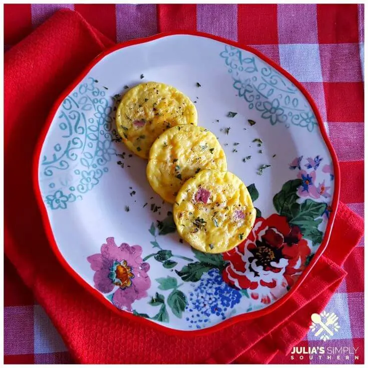 Easy Ham and Cheese Egg Muffins on a floral plate sitting on red and white linens