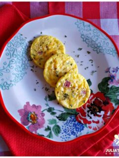 Easy Ham and Cheese Egg Muffins on a floral plate sitting on red and white linens