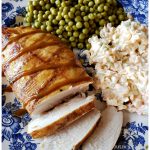 Easy Grilled Carolina Gold Barbecued Chicken Breast on a blue and white plate served with peas and slaw