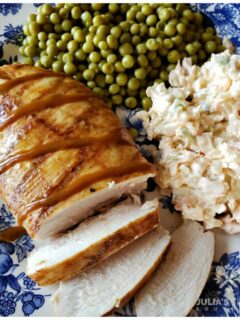 Easy Grilled Carolina Gold Barbecued Chicken Breast on a blue and white plate served with peas and slaw
