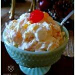 Delicious Southern Ambrosia Salad for parties - sweet side dish in a pretty green milk glass bowl