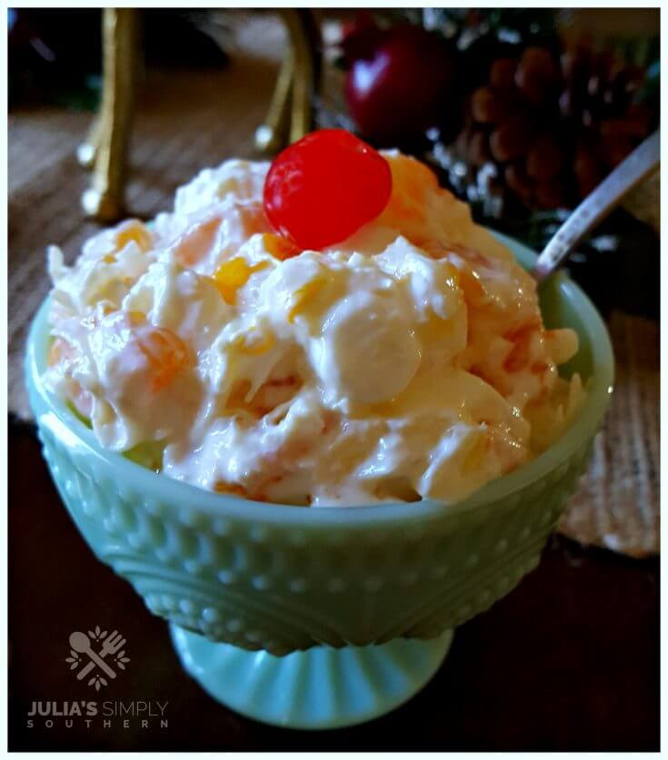 Delicious Southern Ambrosia Salad for parties - sweet side dish in a pretty green milk glass bowl