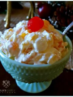 Delicious Southern Ambrosia Salad for parties - sweet side dish in a pretty green milk glass bowl