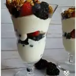 Layered fruit and yogurt parfaits with granola topping in a parfait glass