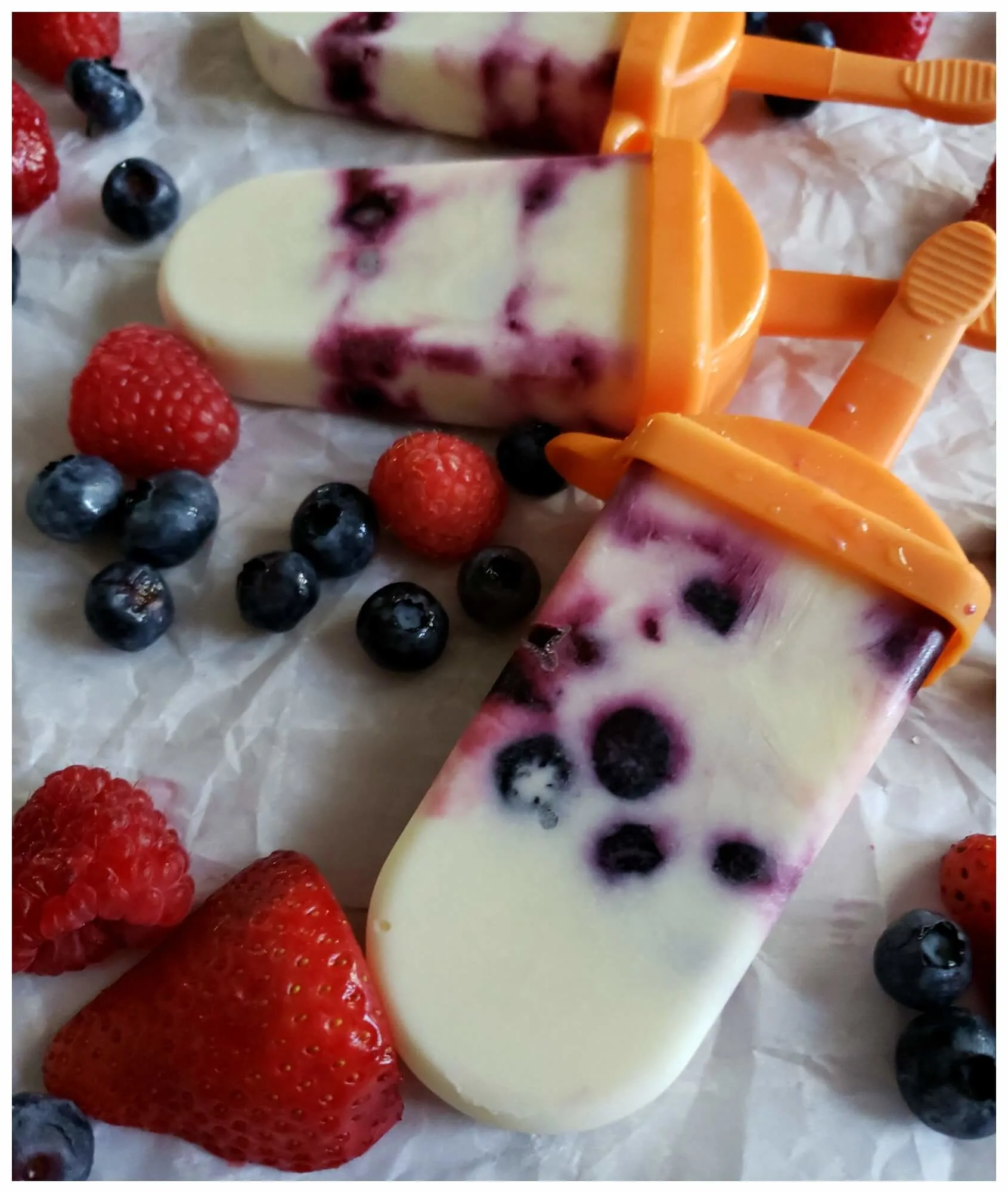 Summer ice cream treats made with frozen vanilla yogurt and fruit in silicone molds