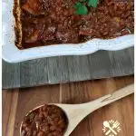 Grandma's Southern Style baked beans with molasses in a white casserole dish. This is a favorite side dish of summer and so easy to prepare.