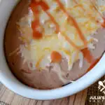 Authentic restaurant style refried beans topped with melted cheese - amazing!