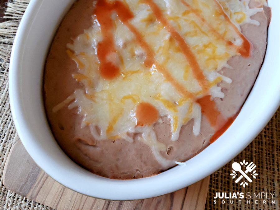 Authentic restaurant style refried beans topped with melted cheese - amazing!