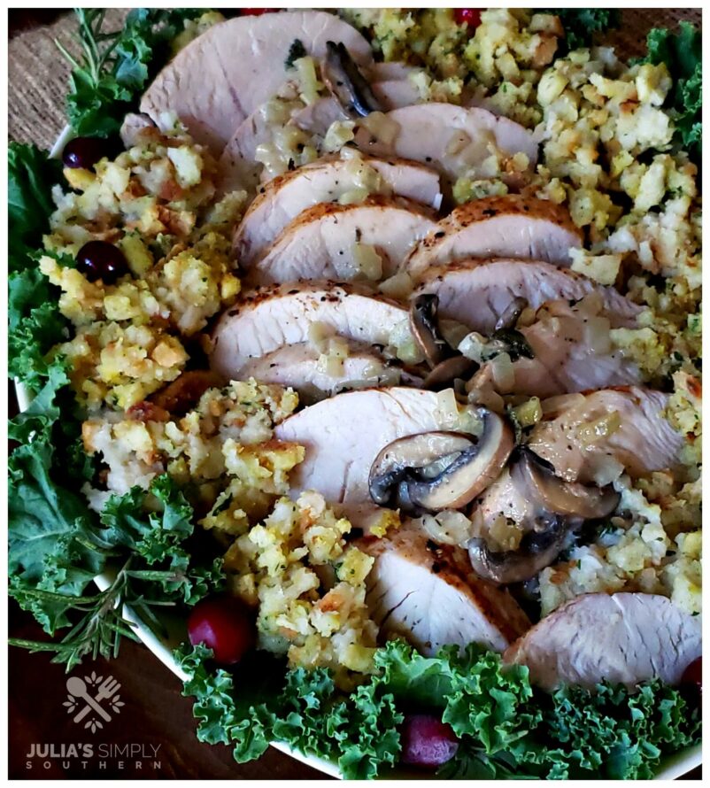 Platter with turkey and stuffing garnished with greenery and cranberries