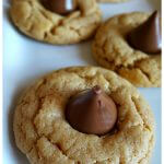 Peanut butter and Hershey Kiss cookies on a white platter