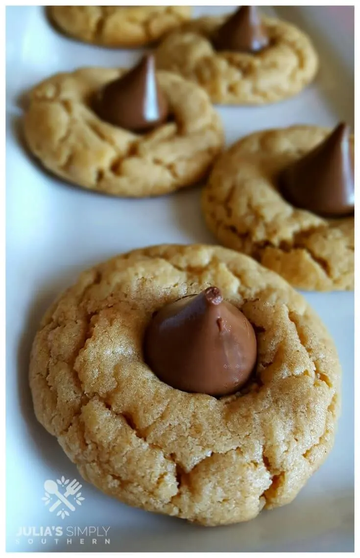 Peanut butter and Hershey Kiss cookies on a white platter