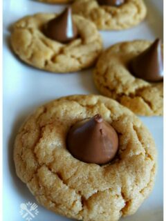 Peanut butter and Hershey Kiss cookies on a white platter