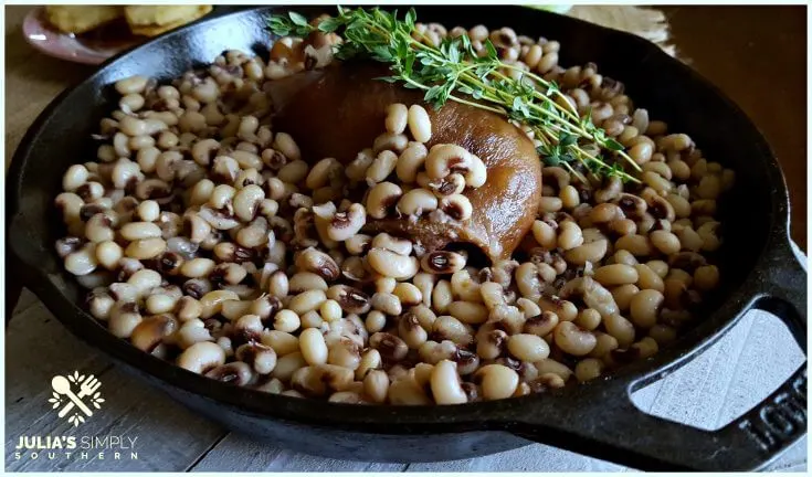 Cast Iron Skillet with Pink eyed peas and a ham hock garnished with fresh Thyme to bring luck in the new year