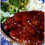 Sticky Garlic Pork Chops on a plate with broccoli and rice