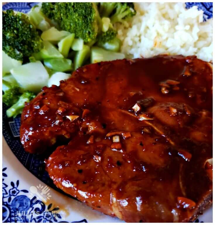 Sticky Garlic Pork Chops on a plate with broccoli and rice