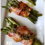 The BEST green bean bundles wrapped in bacon and drizzled with a tangy and delicious sauce