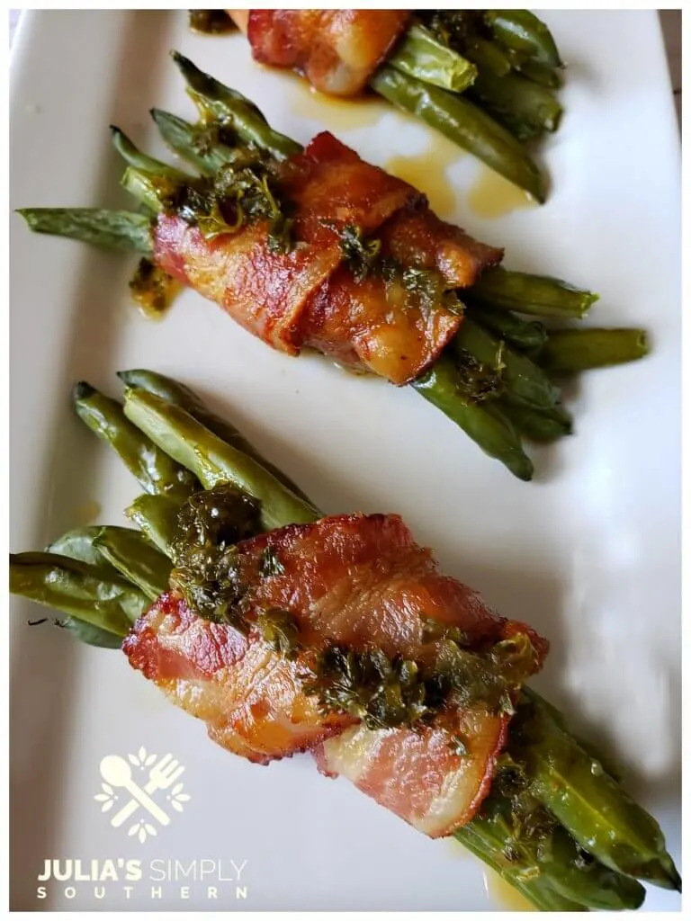 The BEST green bean bundles wrapped in bacon and drizzled with a tangy and delicious sauce