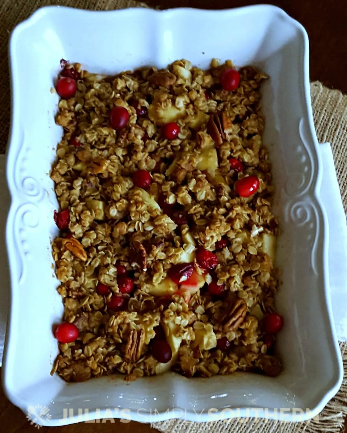 White baking dish with apple cranberry cobbler