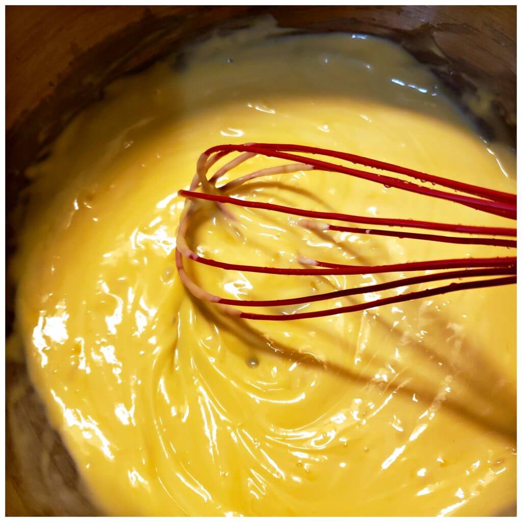 Making a creamy cheese sauce in a pot
