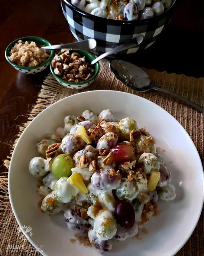 grape salad recipe with pineapple in a serving bowl with brown sugar pecan topping