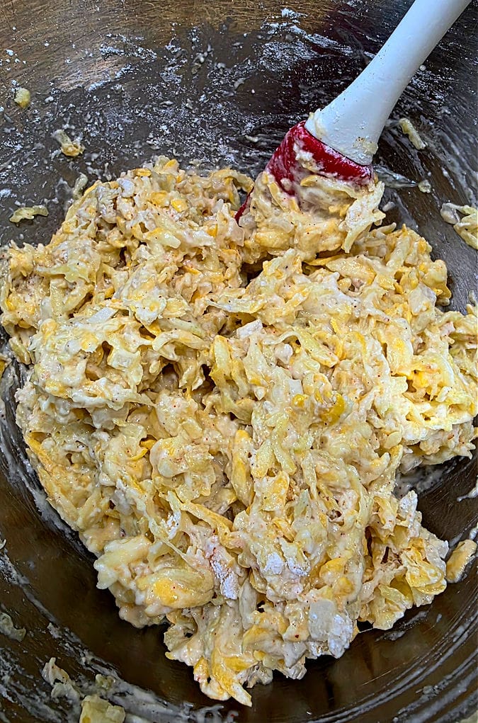Mixing bowl with squash fritter mixture prepared for cooking