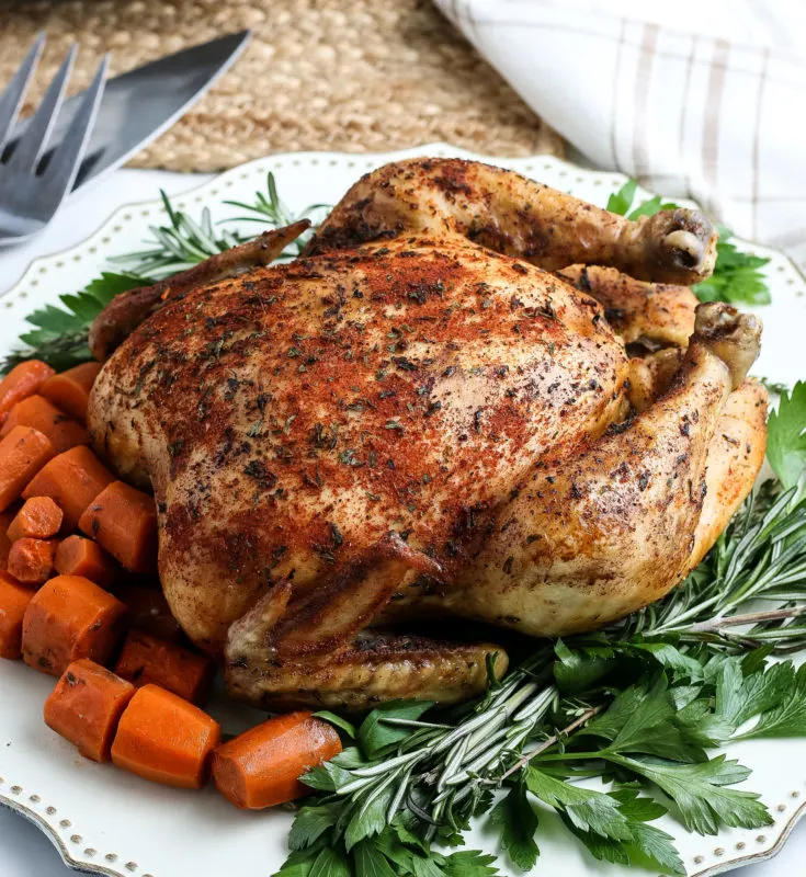 Crock Pot Whole Cooked Chicken on a garnished platter