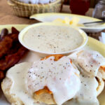 country white gravy with black pepper over a biscuit