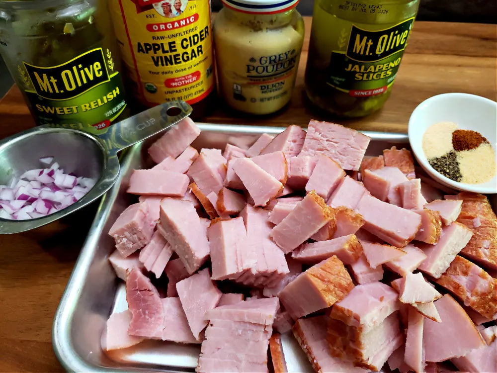 A tray of chopped ham and ingredients prepped for making a batch of deviled ham spread