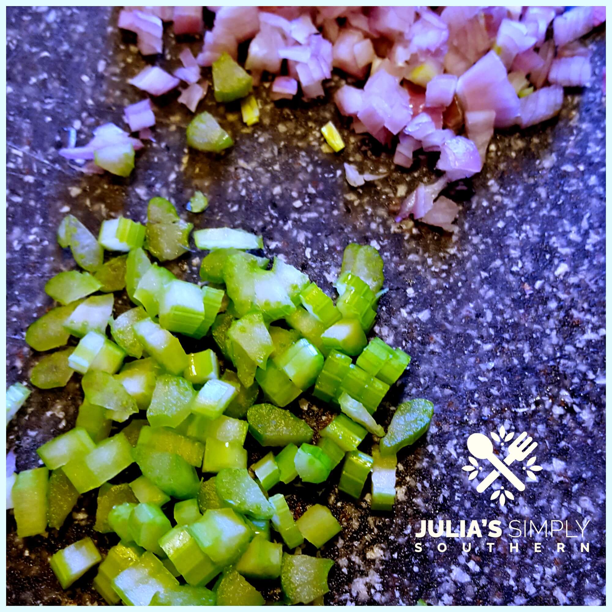 Diced celery and shallots on a cutting board