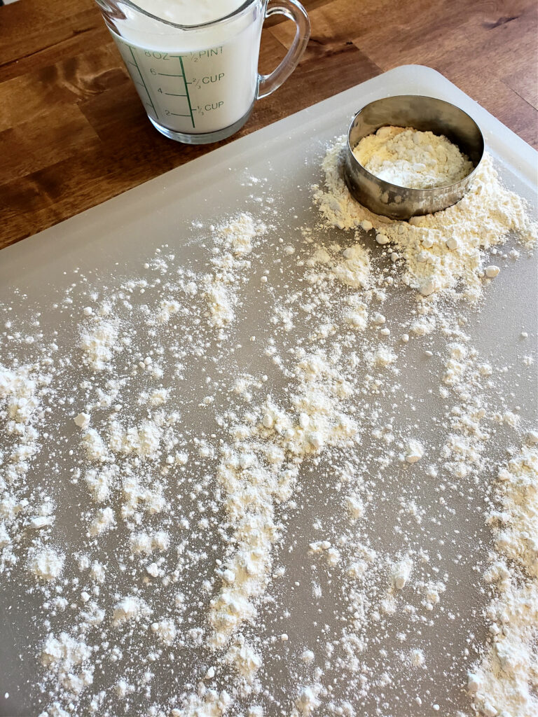 Dusting a surface to roll biscuit dough