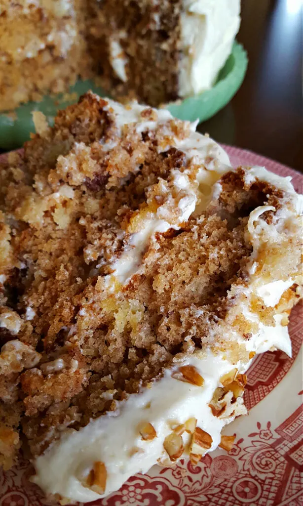 Slice of homemade Hummingbird Cake with cream cheese frosting