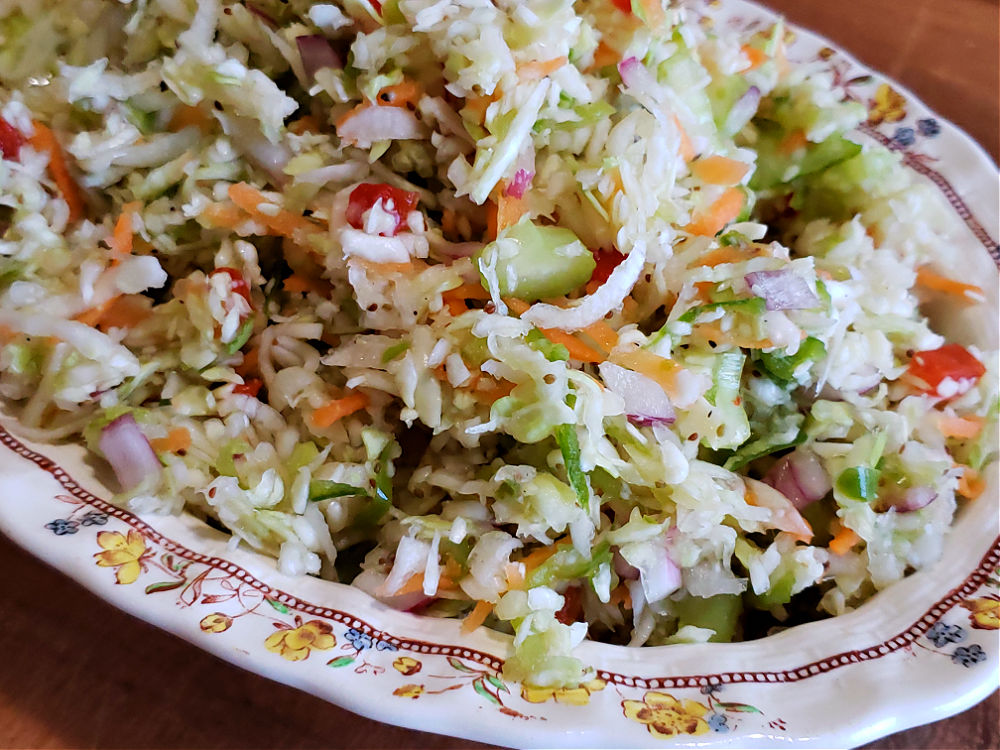 Amish overnight coleslaw recipe, also known as pepper slaw, with a no mayo vinegar dressing in a serving bowl