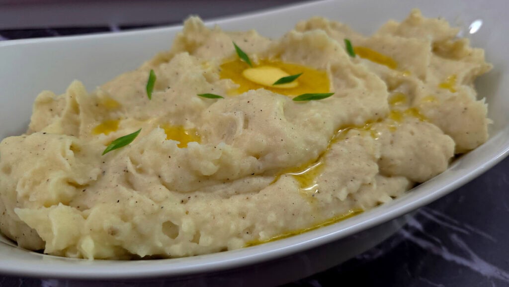 Creamy Southern buttermilk mashed potatoes topped with melted butter and fresh herbs